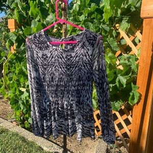 This blouse can be dressed up or down.  Very comfortable , light, and airy.